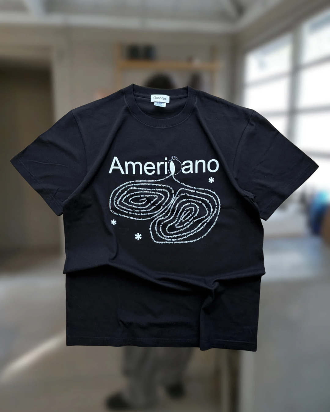 Black)Americano spilling tee